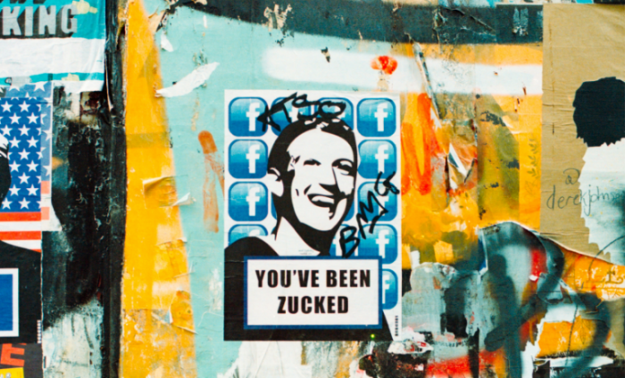 Graffiti on a wall of a photo of Mark Zuckerberg 