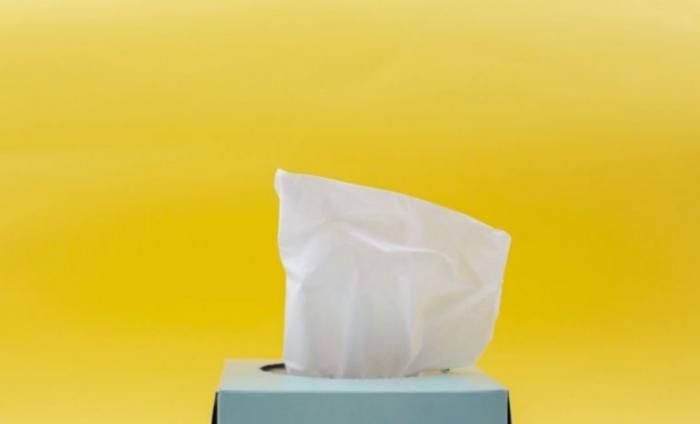 Box of tissues with a bright yellow background