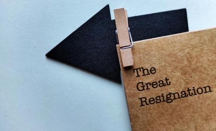 Notebook with the title "the great resignation' clipped to an arrow pointing left.