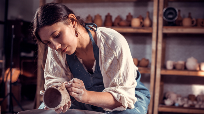 Woman crafting a clay mug