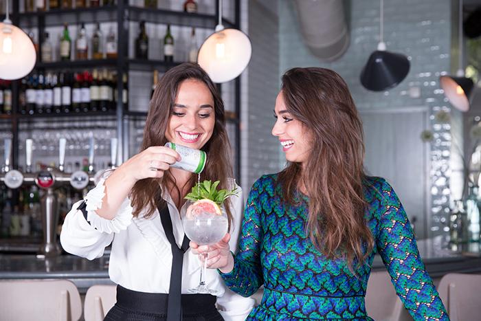 Joyce and Raissa De Haas making a gin and tonic with their mixers