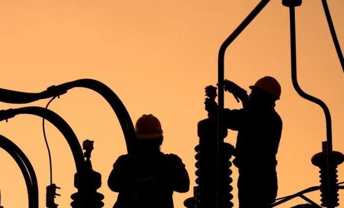 Workers setting up an electric sub station in Latin America